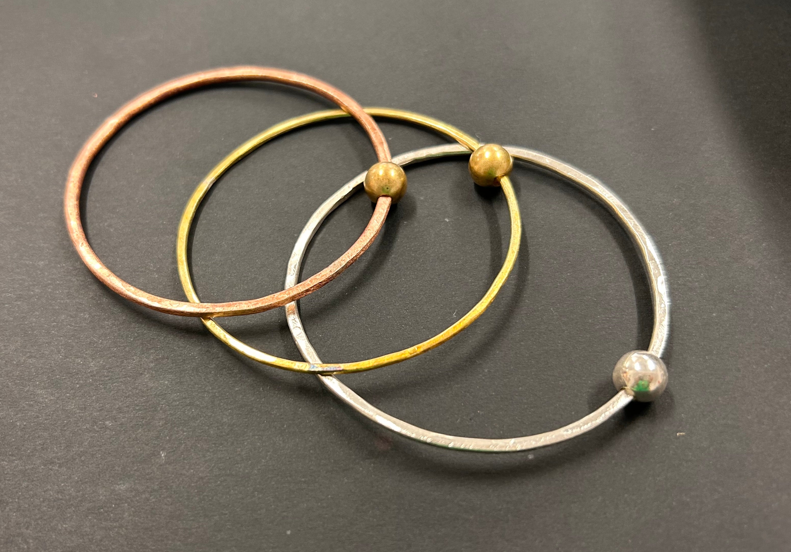 Thin copper bangle with round brass bead