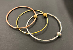 Thin copper bangle with round brass bead