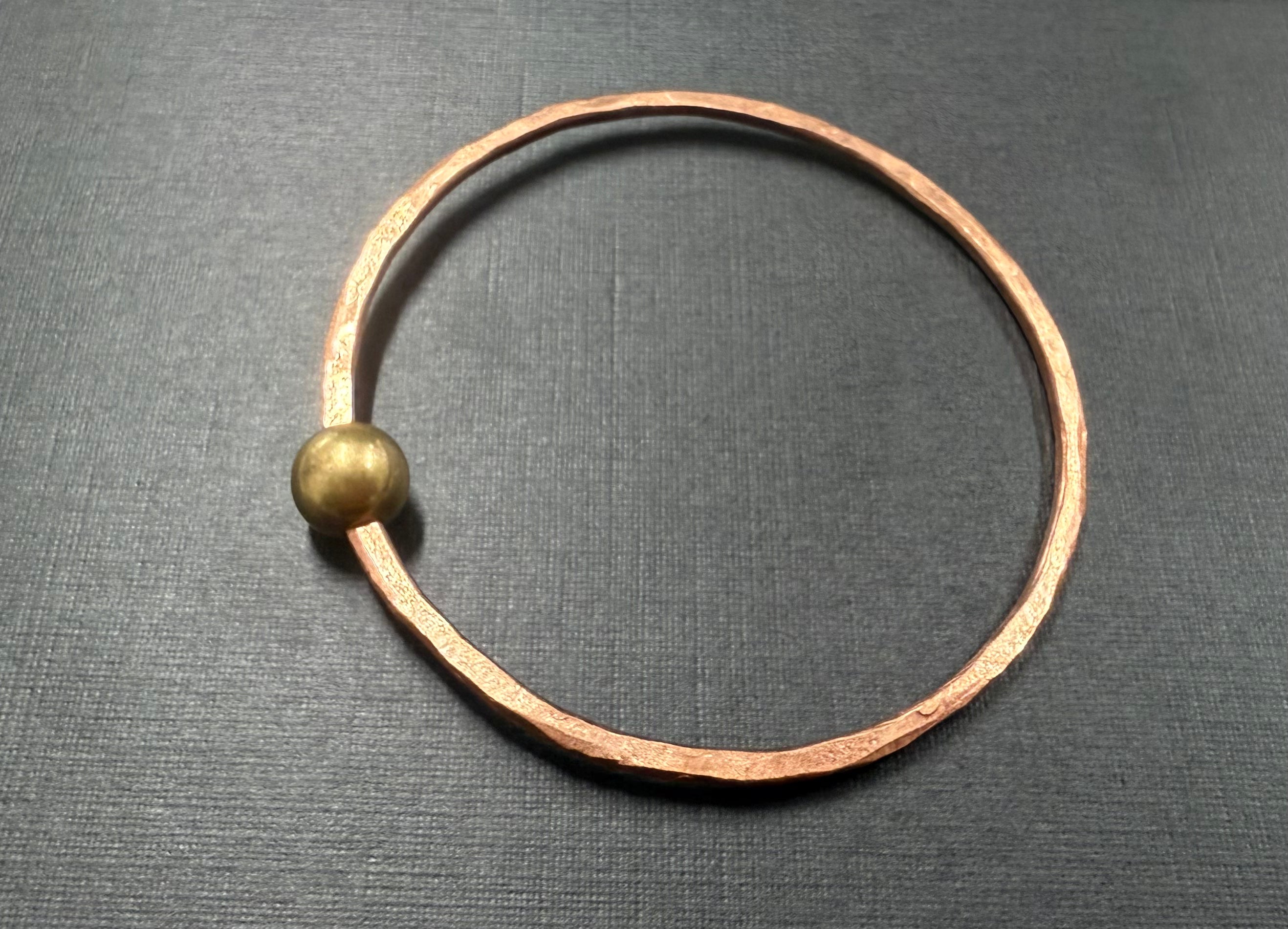 Thin copper bangle with round brass bead