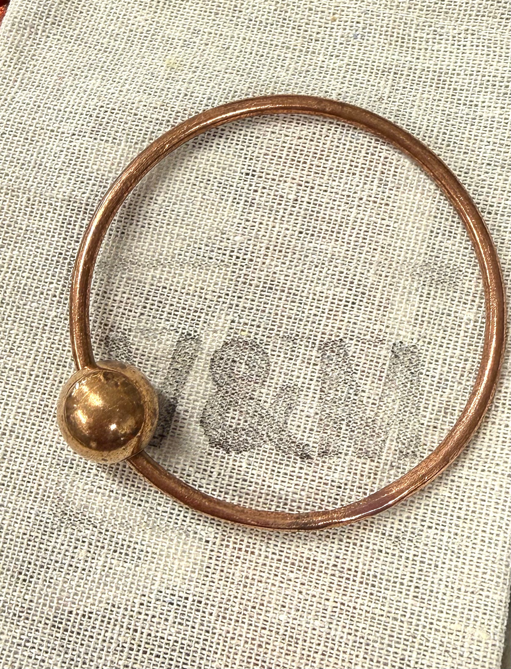 Thin copper bangle with feature bead