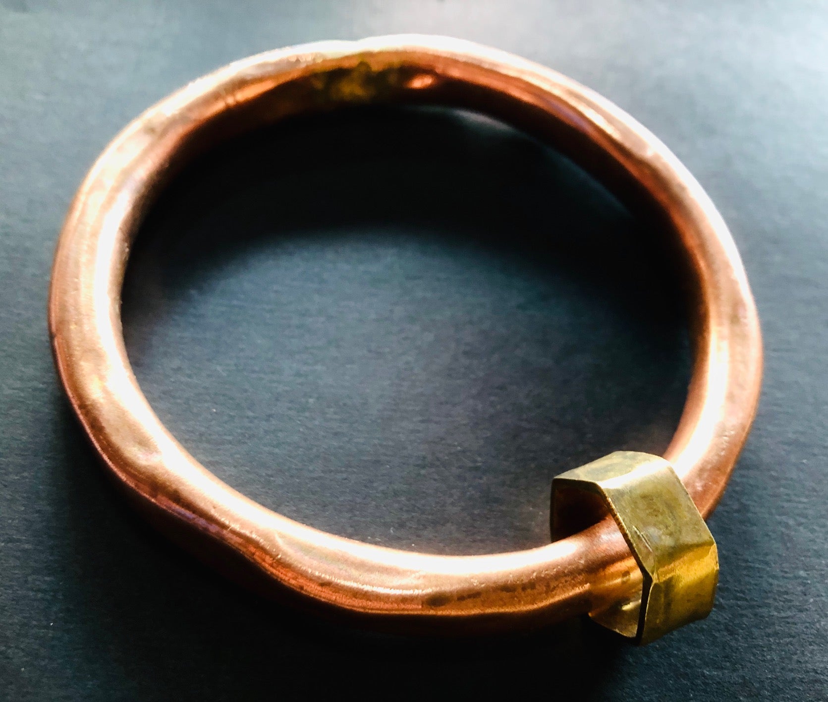 Copper anvil bangle with brass shape