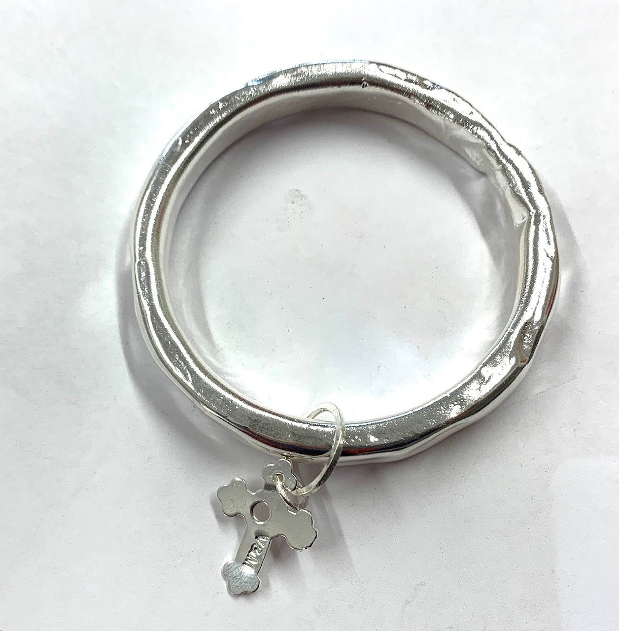 Silver anvil bangle with cross