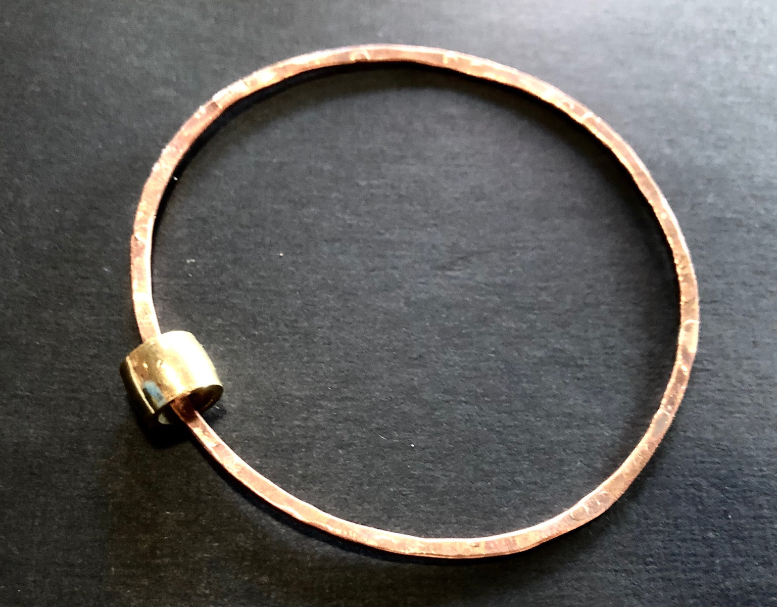 Thin copper bangle with brass bead