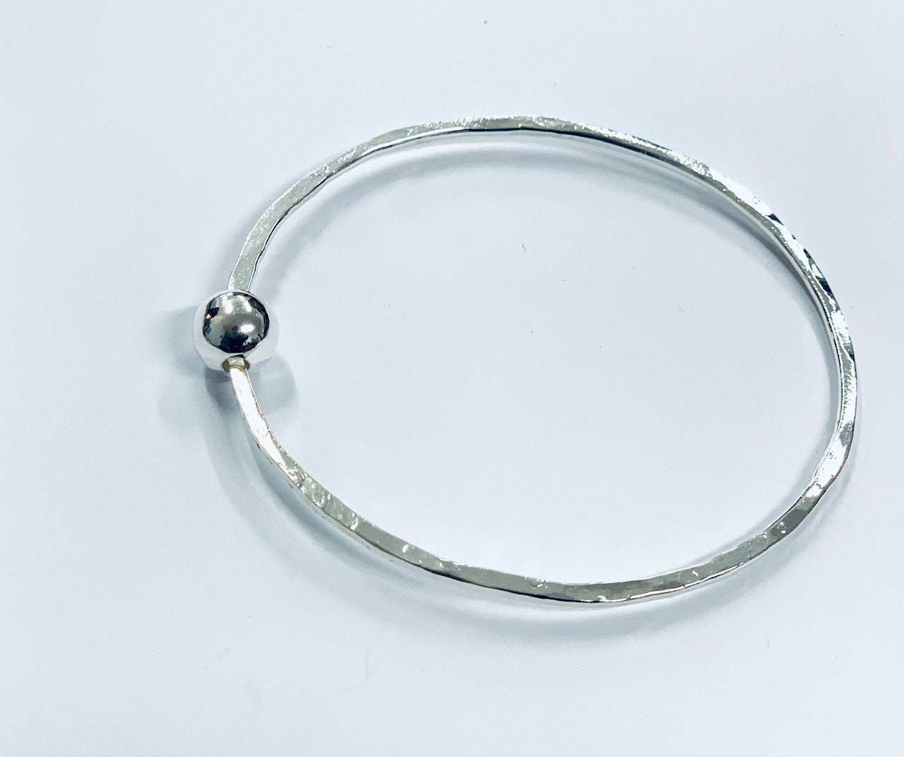Thin silver bangle with round bead