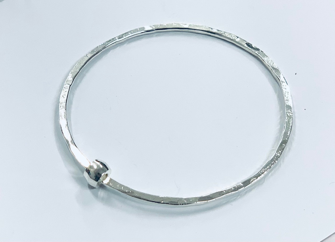 Thin silver bangle with barrel bead
