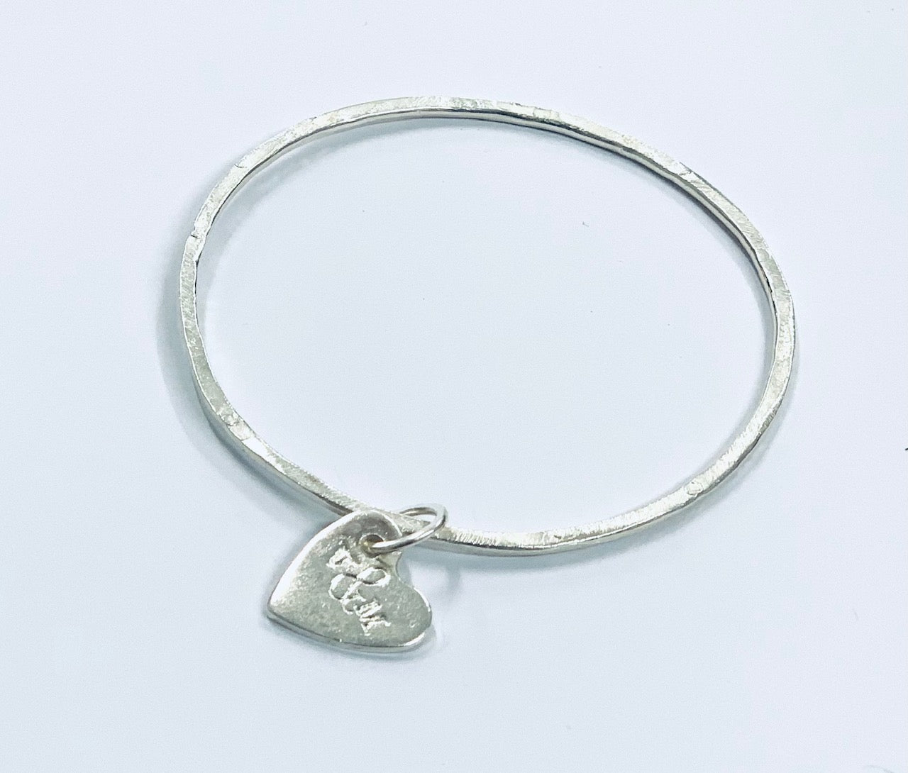 Thin silver bangle with heart